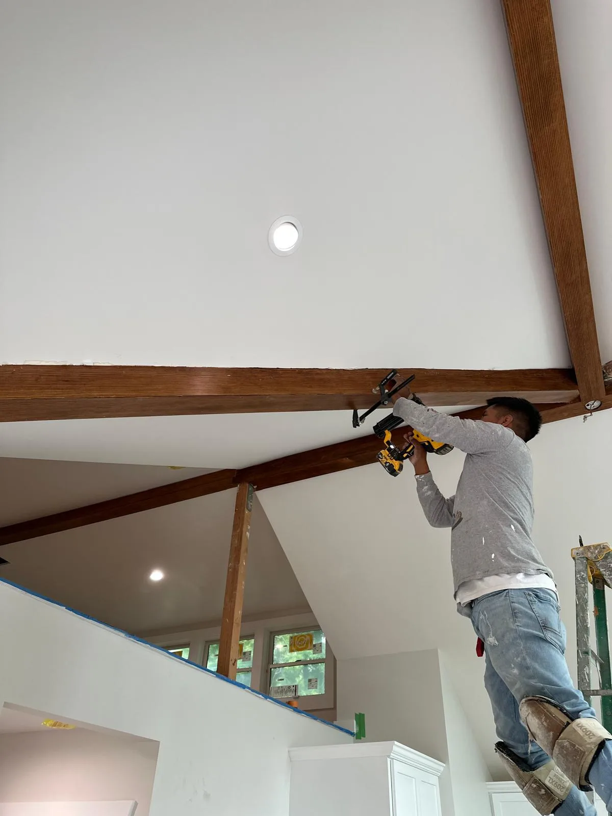 Ivan's Pro Painting crew member painting exterior trim