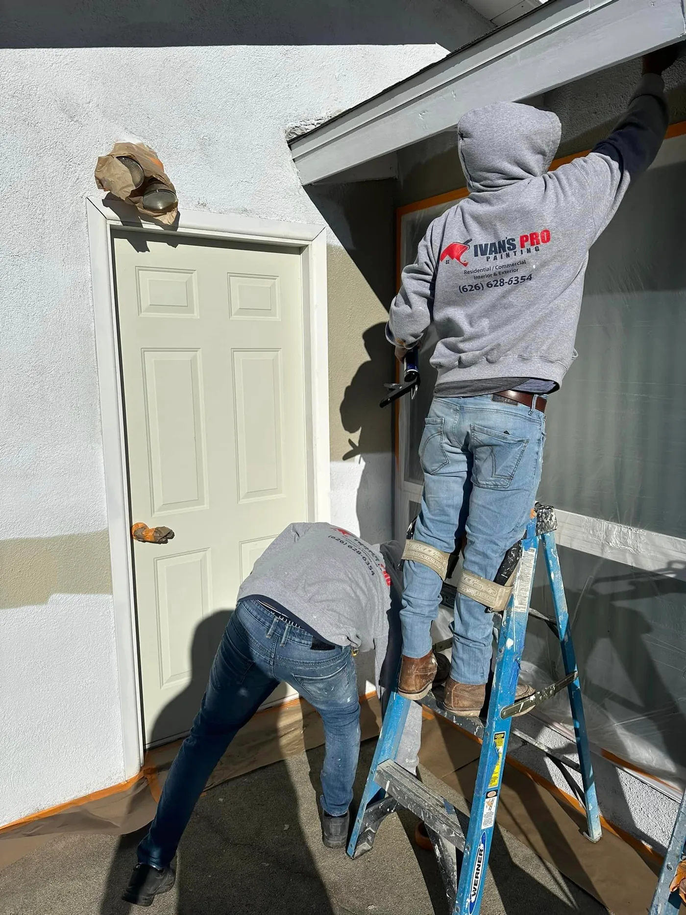 Ivan's Pro Painting crew preparing a surface before painting