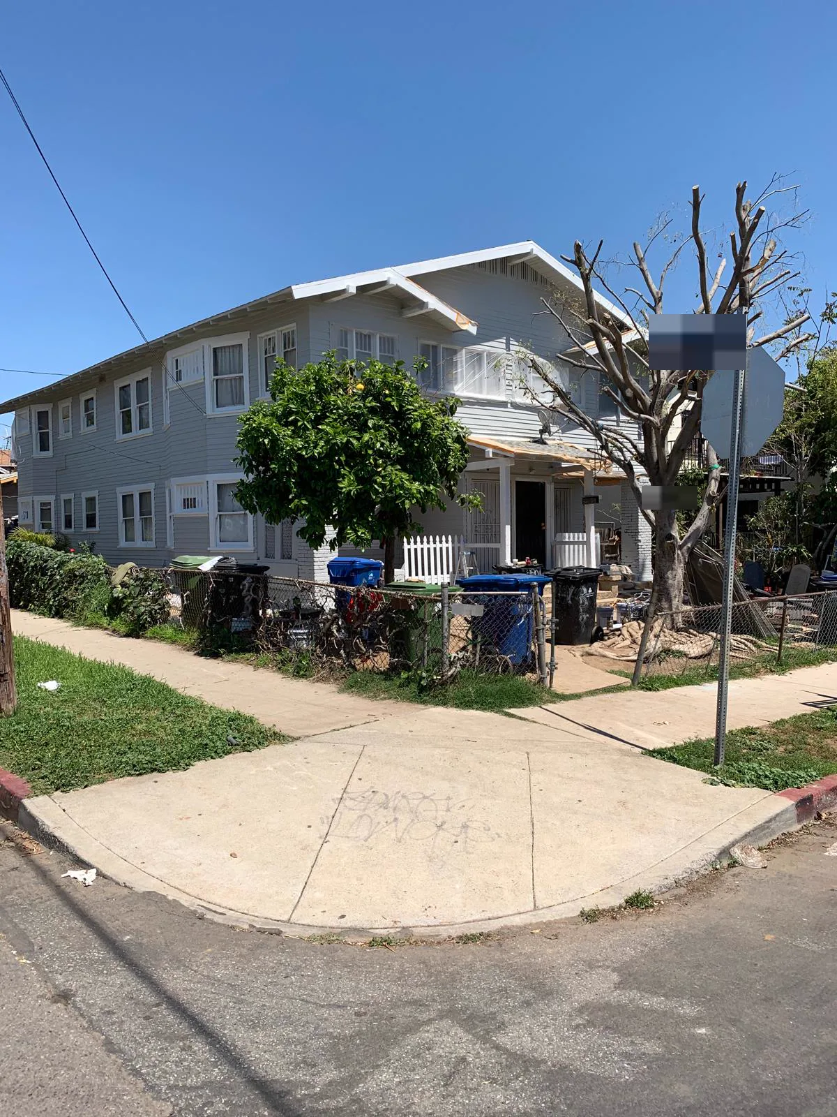 Two-story Alhambra Craftsman repainted grey with white trim, seen from the corner
