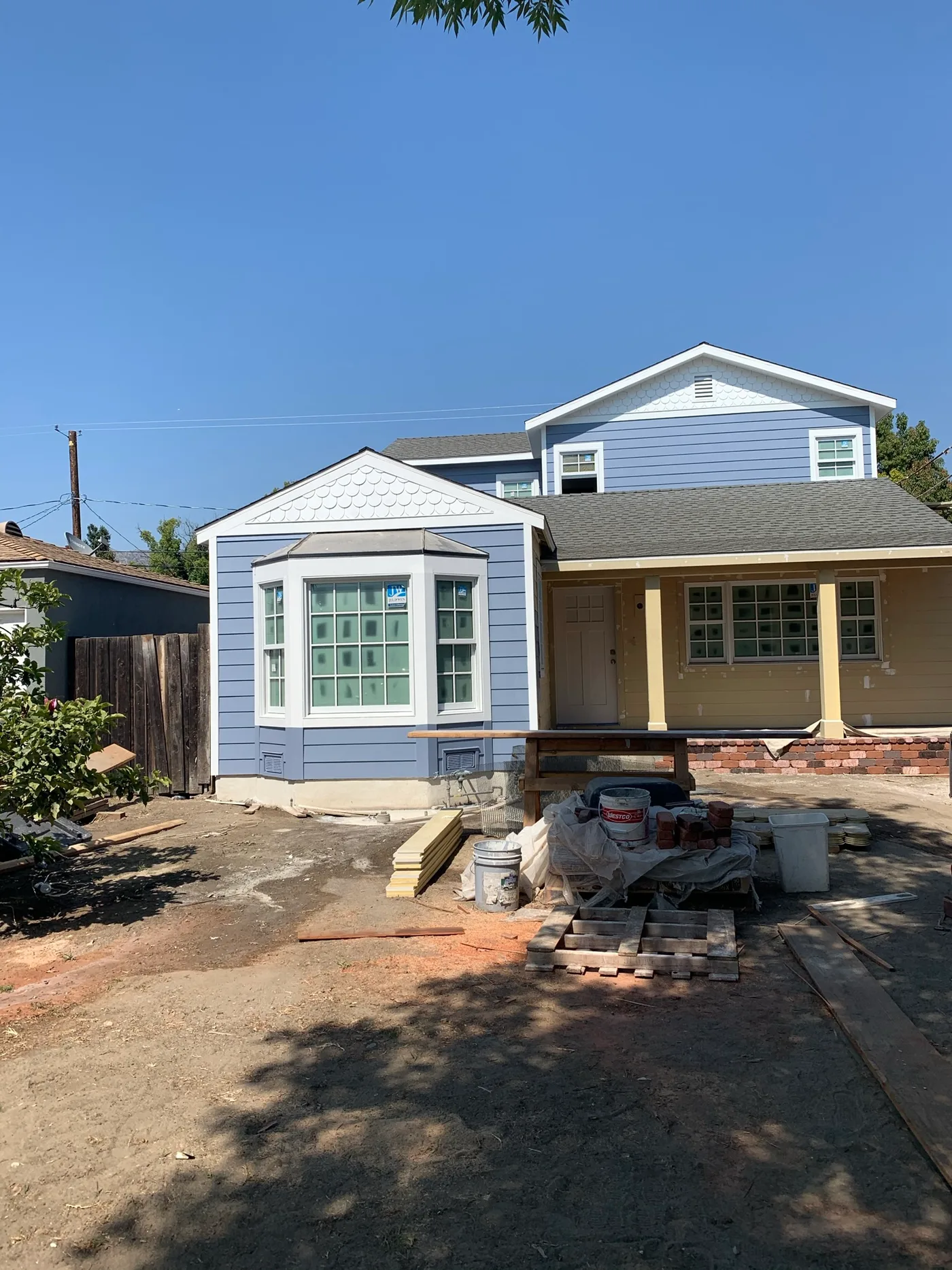 The same Altadena home after Ivan's Pro Painting finished the exterior in blue-grey with white trim