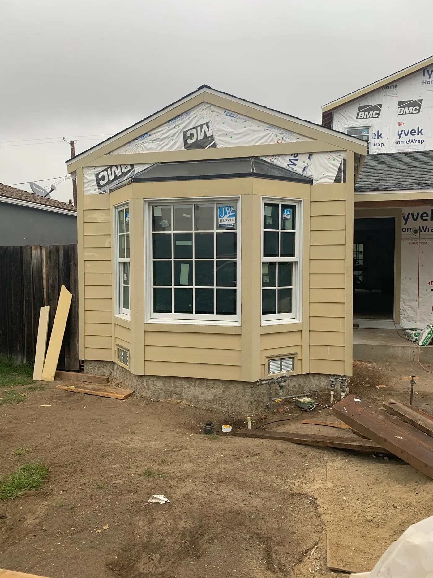 Altadena home mid-project with bare siding and house wrap before painting by Ivan's Pro Painting