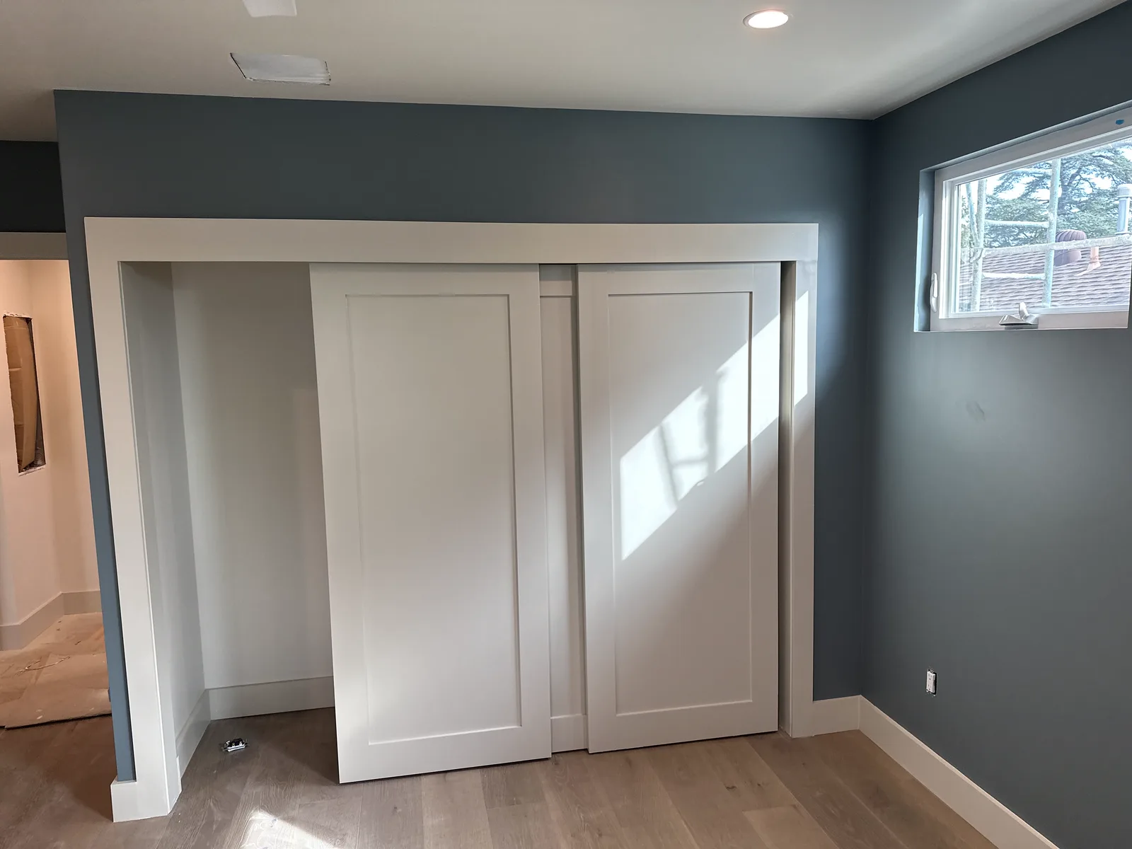 Altadena bedroom repainted slate blue with white closet doors and trim