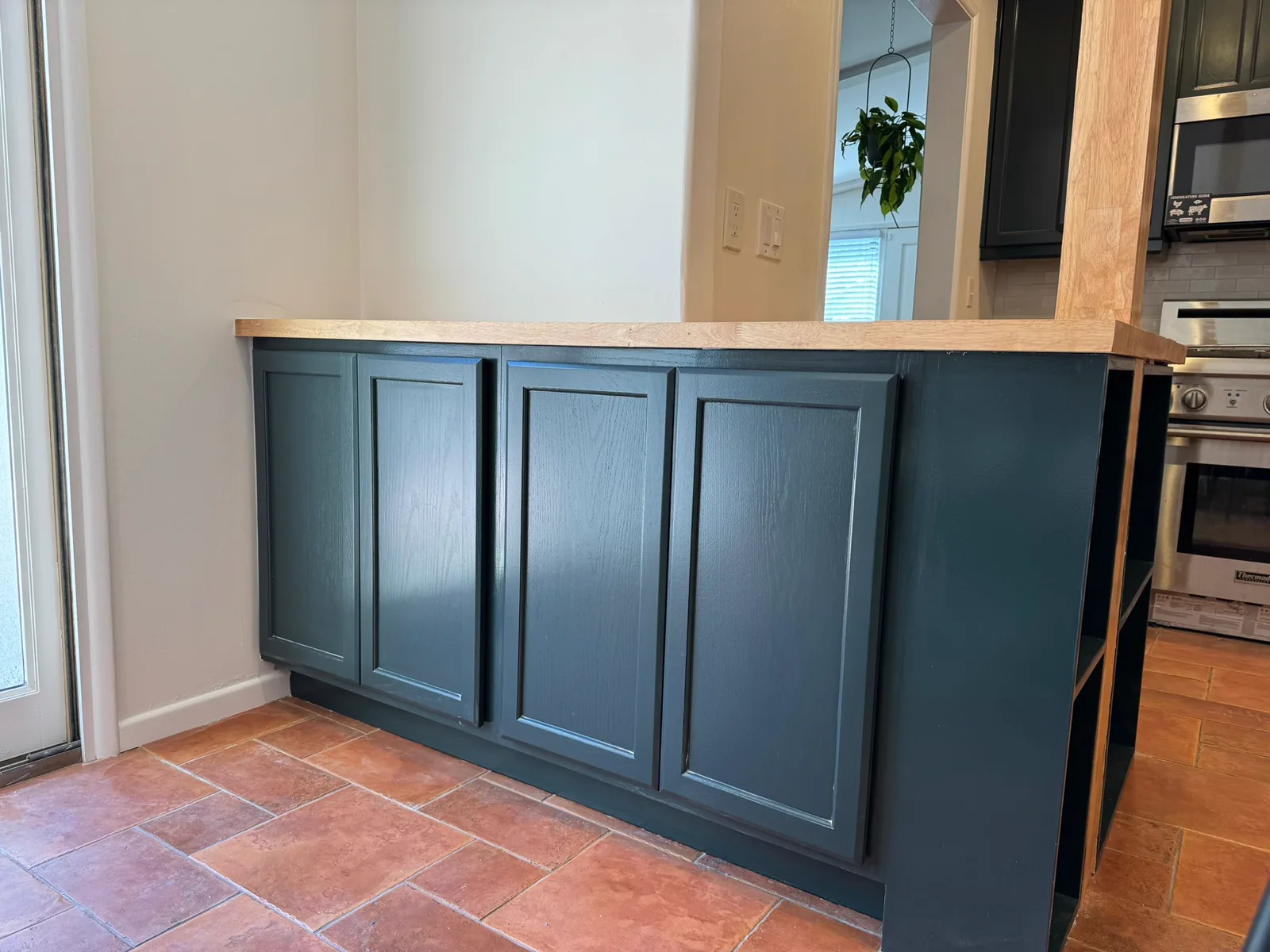 Second view of the refinished green kitchen cabinetry in Arcadia