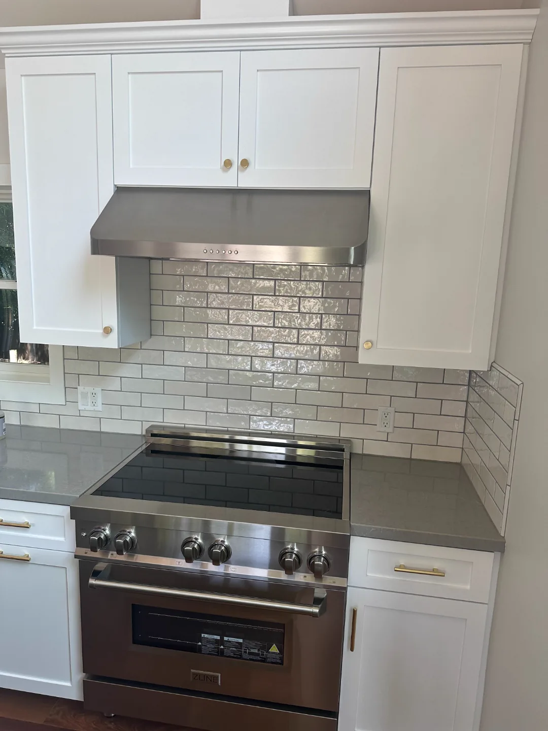 Refinished white kitchen cabinets with gray counters in a San Gabriel home