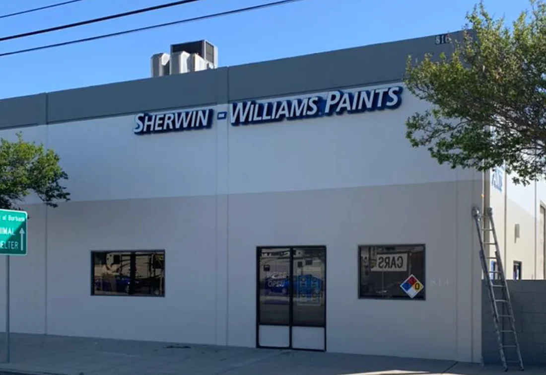 Completed commercial paint store exterior with clean white and gray finish