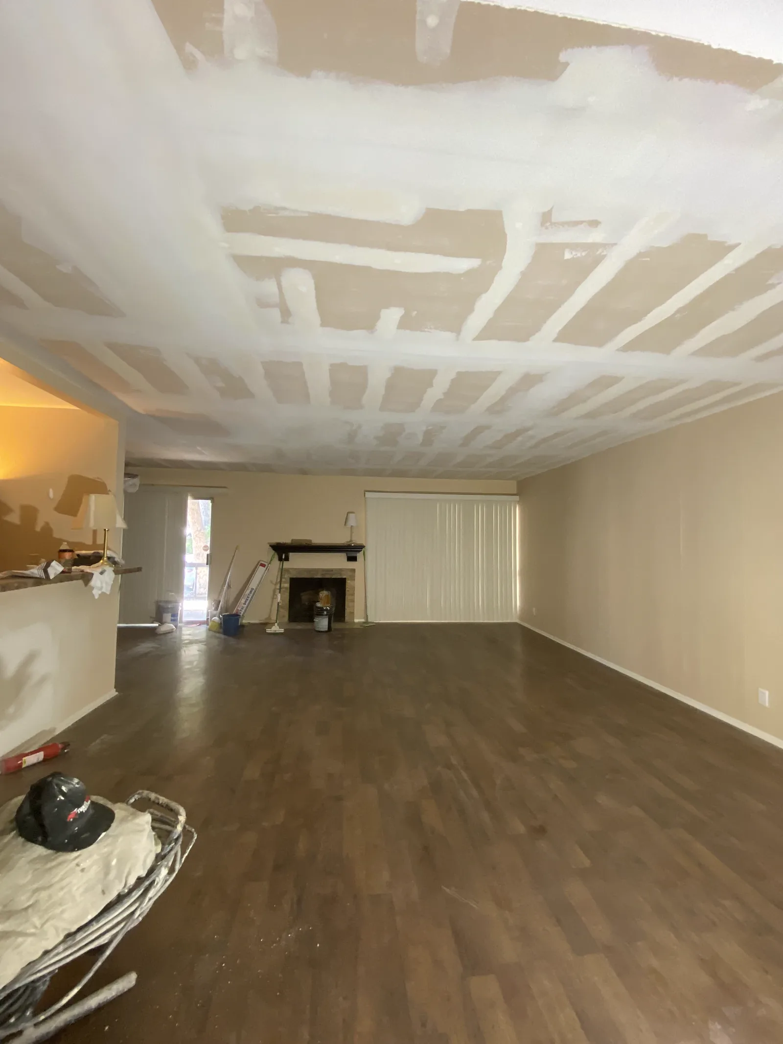 Living room ceiling taped and coated across the full span before priming