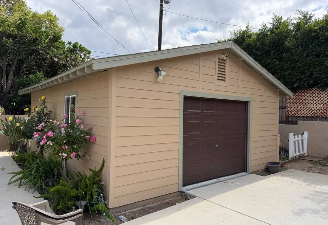 Completed detached garage exterior in warm neutral colors