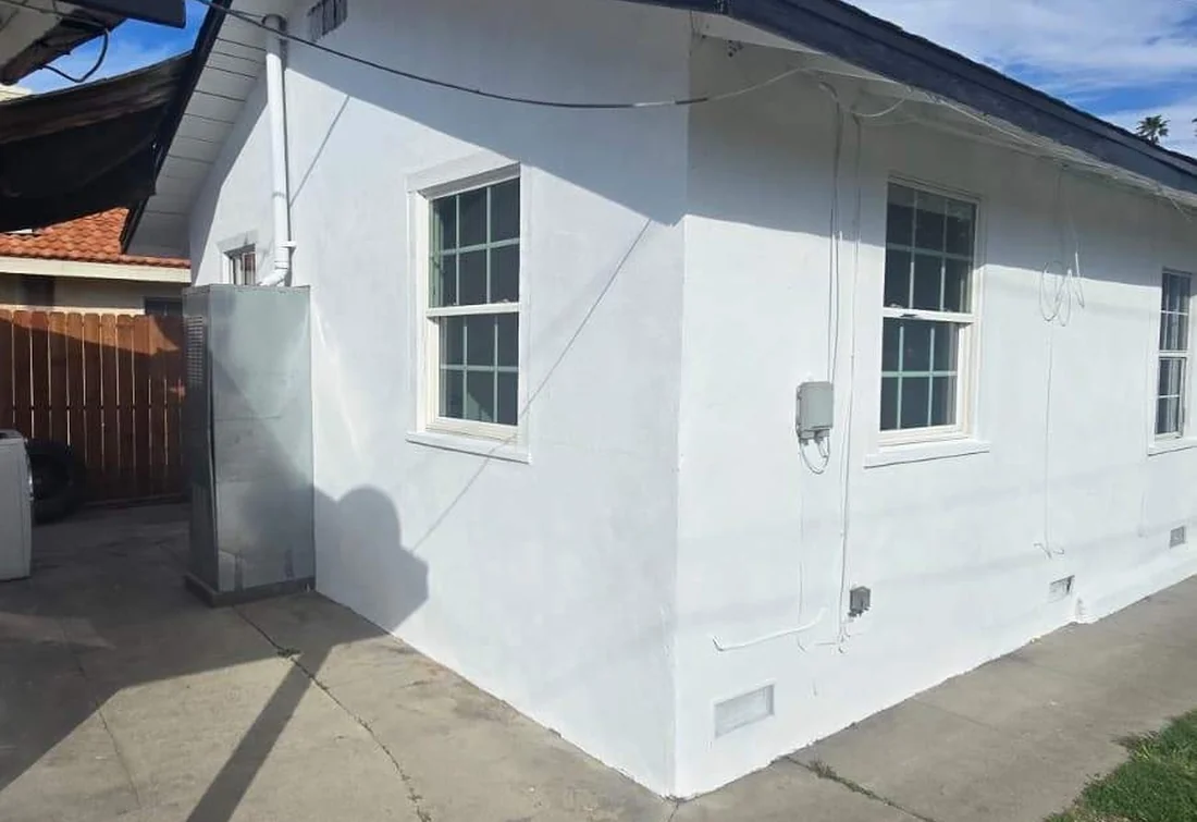 Completed white residential stucco exterior