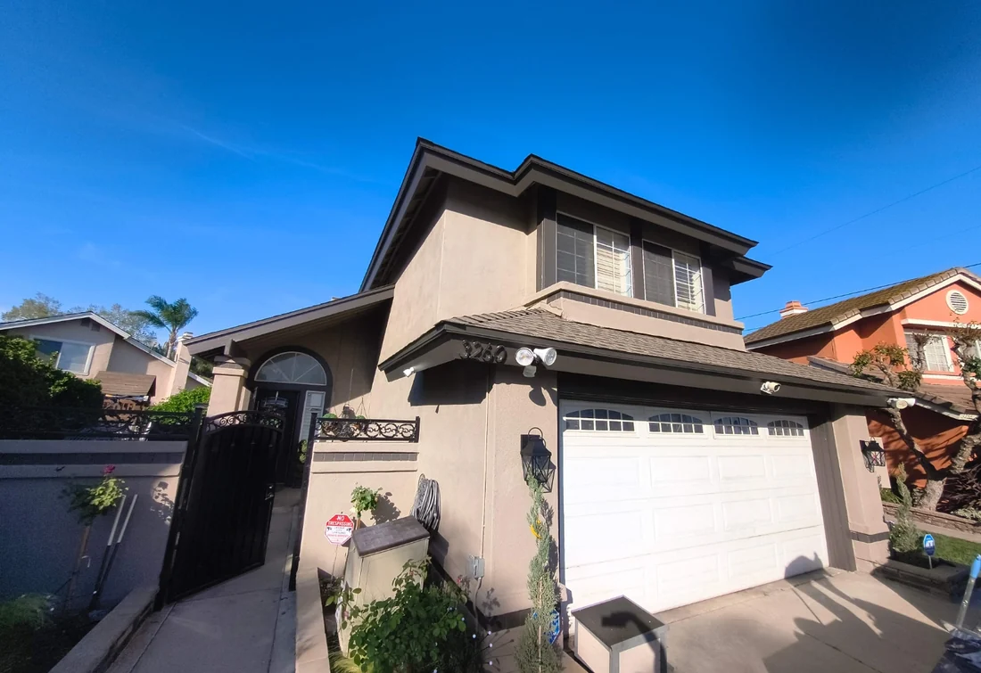 Completed two-story home exterior in taupe and cream