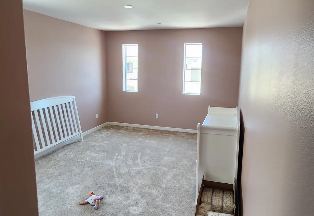 Completed bedroom repaint in a warm cream color