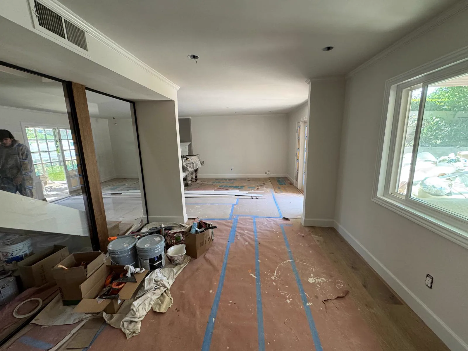 Interior with floors papered and taped and fixtures masked before painting