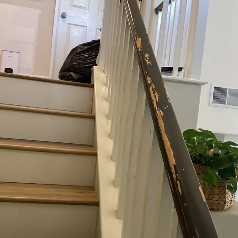 Worn stair railing before refinishing
