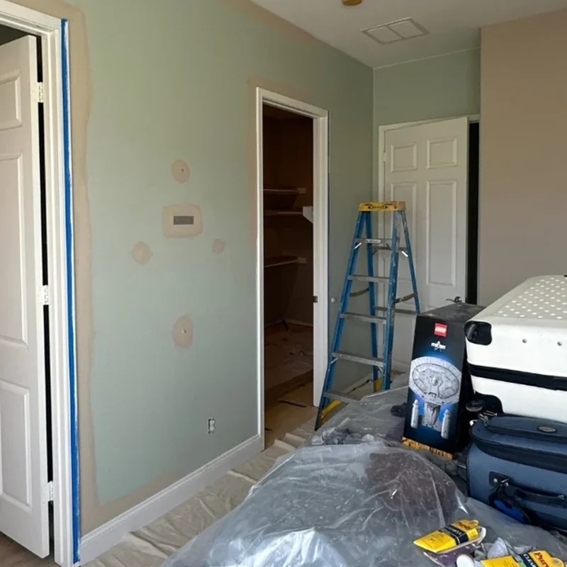 Bedroom before wall repair and repainting