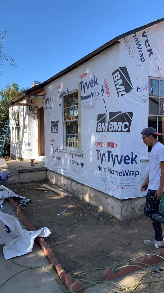 Crew replacing damaged siding before painting