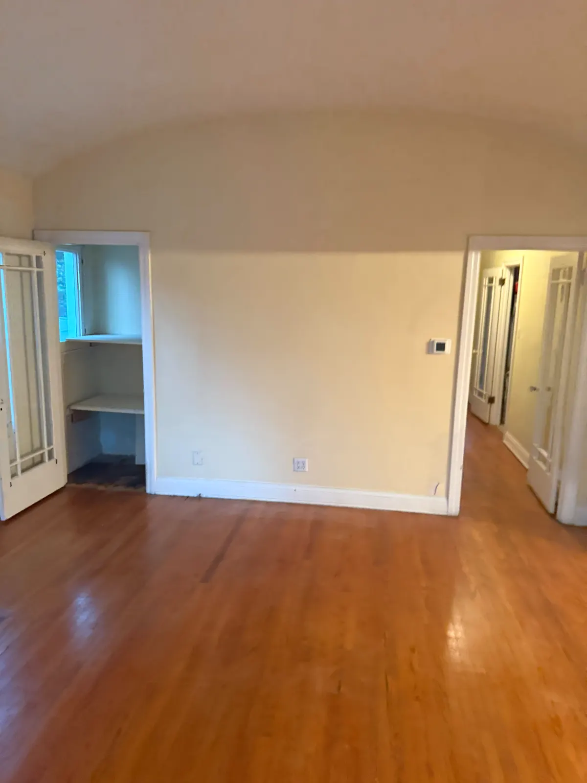 Pasadena room with a built-in and original doors, plaster walls before crack repair