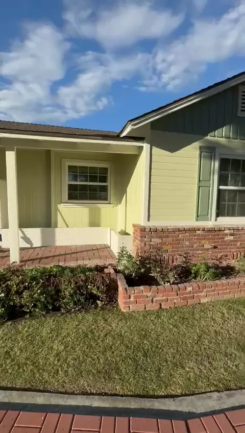 Front corner of the finished Pasadena ranch with a sage gable, sage shutters and white trim