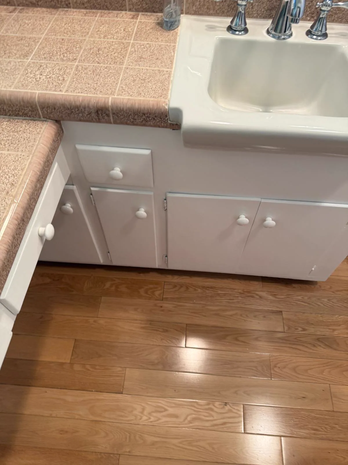 Dated pink bathroom vanity cabinets in a San Gabriel home before refinishing