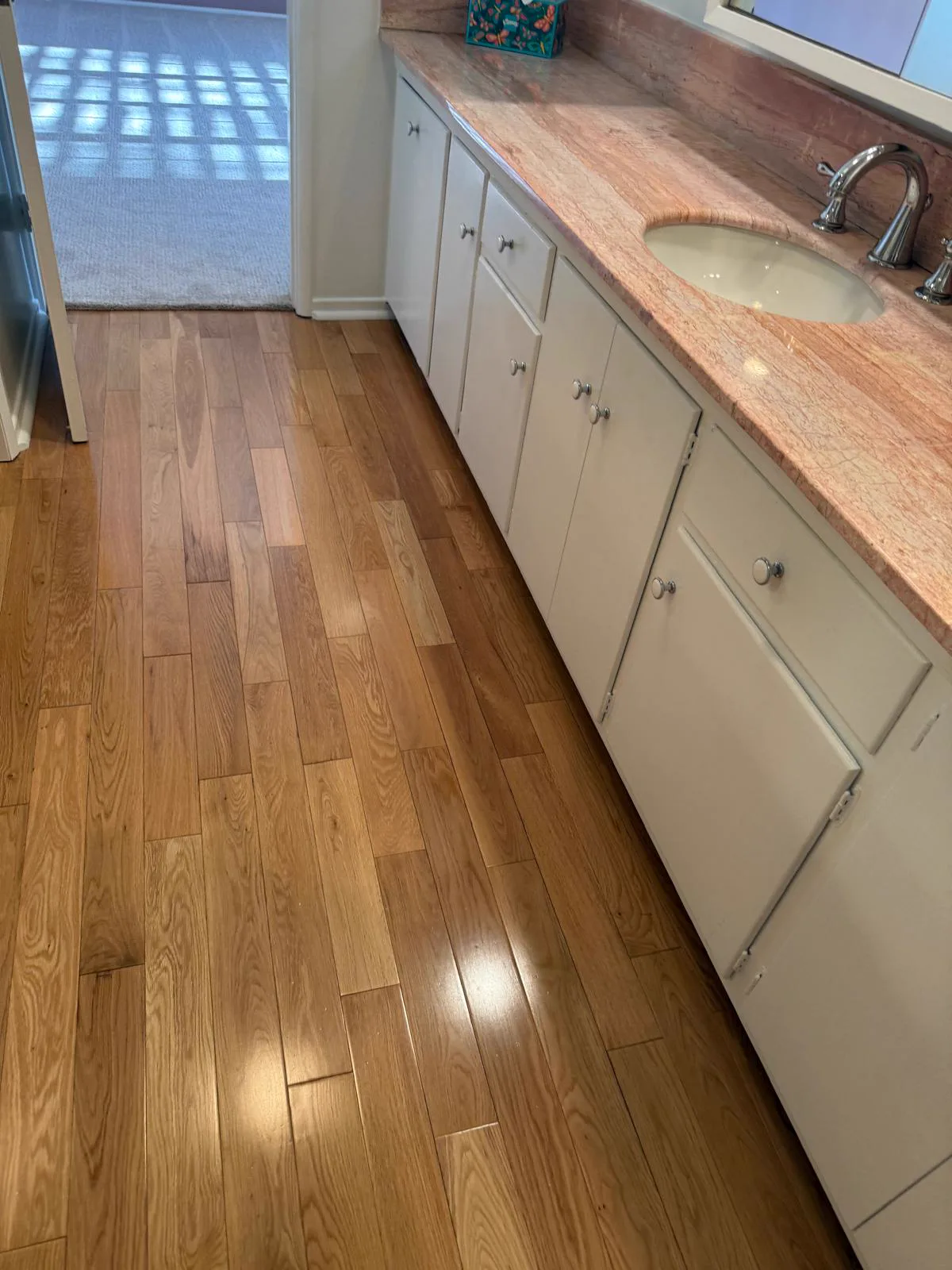 Dated master bathroom cabinets before refinishing in a San Gabriel home