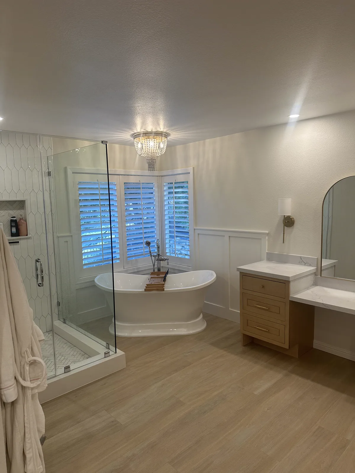 Finished South Pasadena bathroom with a freestanding tub, plantation shutters and a glass shower