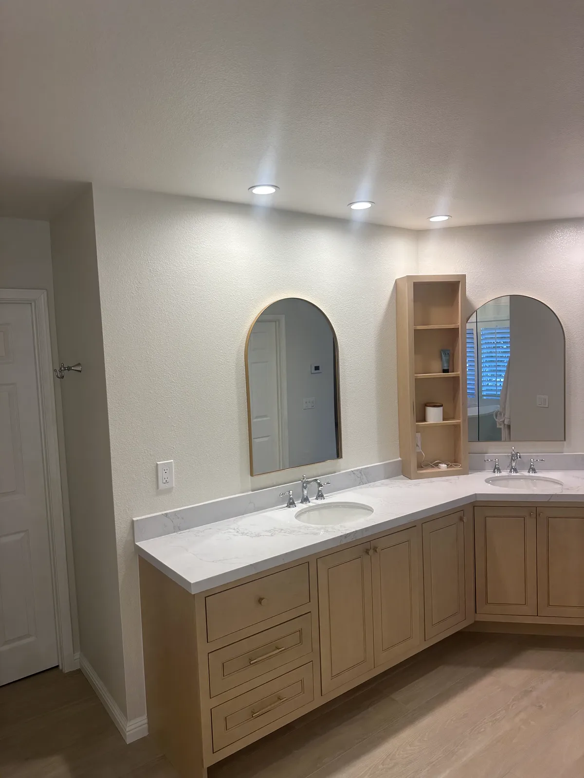 Double vanity with arched mirrors in a finished South Pasadena bathroom
