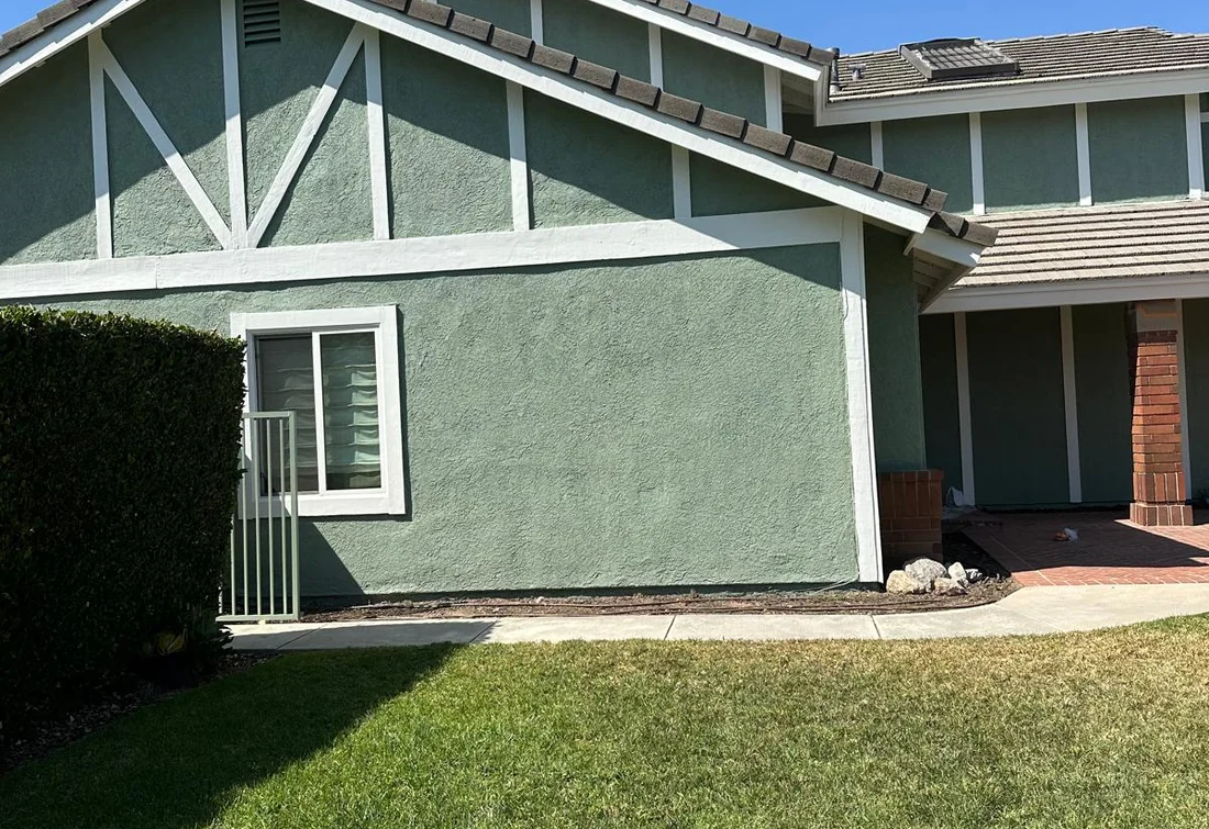 Completed green stucco home exterior