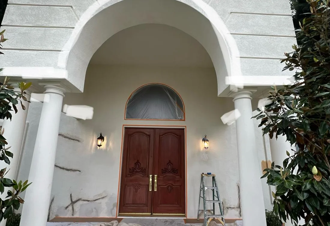 Arched stucco entry prepared for repair