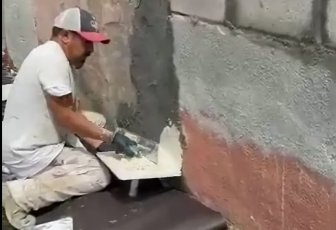 Stucco material being applied by hand